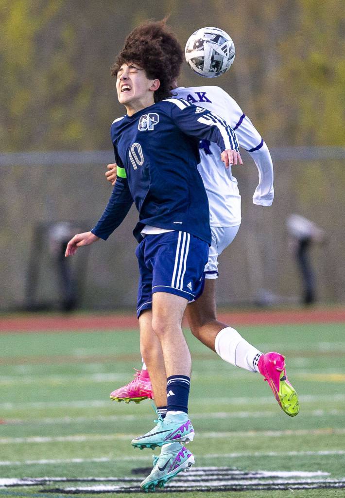 Glacier Peaks Nicholas Miller and Kamiaks Saikou Bojang both leap in the air for a head ball during the game on Monday, April 1, 2024 in Snohomish, Washington. (Olivia Vanni / The Herald)