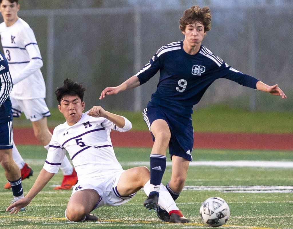 Glacier Peaks Liam Smith escapes a slide tackle by Kamiaks Zion An during the game on Monday, April 1, 2024 in Snohomish, Washington. (Olivia Vanni / The Herald)