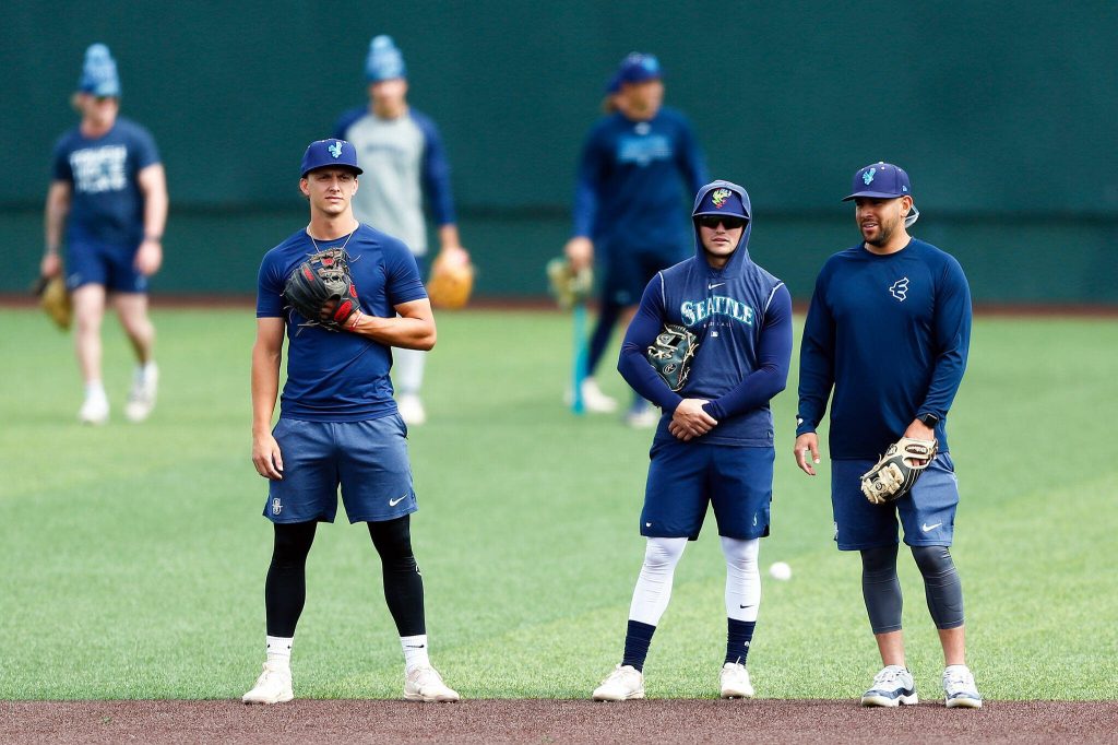 A group Everett AquaSox infielders take turns fielding grounders during practice Tuesday, April 2, 2024, at Funko Field in Everett, Washington. (Ryan Berry / The Herald)