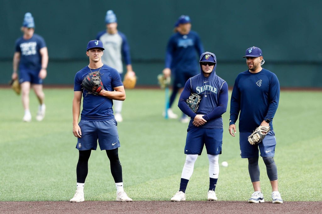 A group Everett AquaSox infielders take turns fielding grounders during practice Tuesday, April 2, 2024, at Funko Field in Everett, Washington. (Ryan Berry / The Herald)