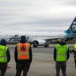 Airport workers watch as an Alaska Airlines Boeing 737 embarks on the first 737 flight out of Paine Field Airport Thursday, Feb. 17, 2022, in Everett, Washington. (Ryan Berry / The Herald)
