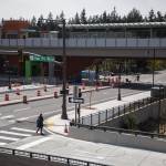 Pedestrians and bicyclists cross the street next to the new Mountlake Terrace Link station on Wednesday, April 10, 2024 in Mountlake Terrace, Washington. (Olivia Vanni / The Herald)