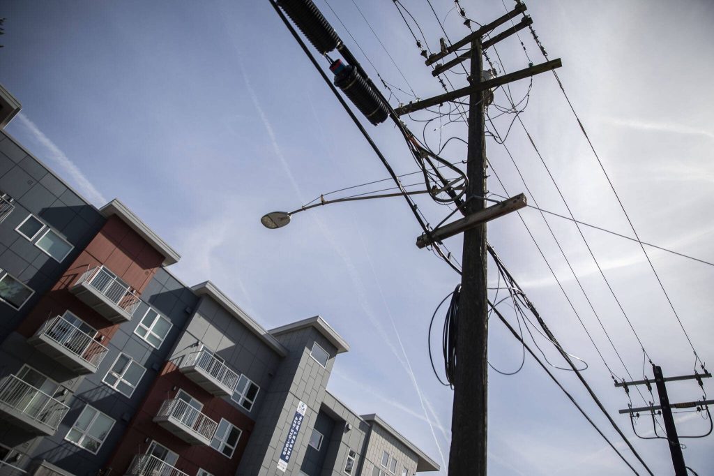 New housing and power lines that will be moved underground as part of the development of the Mountlake Terrace Town Center on Wednesday, April 10, 2024 in Mountlake Terrace, Washington. (Olivia Vanni / The Herald)