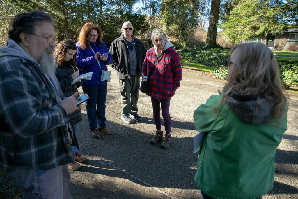 Neighbors gather on their street to talk about a long string of nuisances they have experienced due to DTG Enterprises operating so close to their homes on Tuesday, March 5, 2024, in Snohomish, Washington. (Ryan Berry / The Herald)