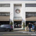 Pedestrians cross the street in front of Edmonds City Hall on Thursday, Dec. 28, 2023 in Edmonds, Washington. (Olivia Vanni / The Herald)