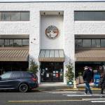 Pedestrians cross the street in front of Edmonds City Hall on Thursday, Dec. 28, 2023 in Edmonds, Washington. (Olivia Vanni / The Herald)