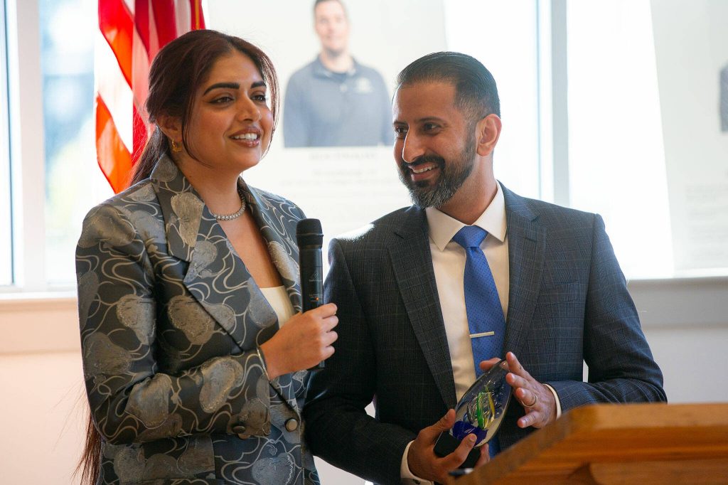Co-founders of Symmetria Integrative Medical Lavleen Samra-Gill and Dr. Baljinder S. Gill accept the inaugural Emerging Business Award during the 2024 Snohomish County Emerging Leaders Awards Presentation on Wednesday, April 17, 2024, in Everett, Washington. (Ryan Berry / The Herald)