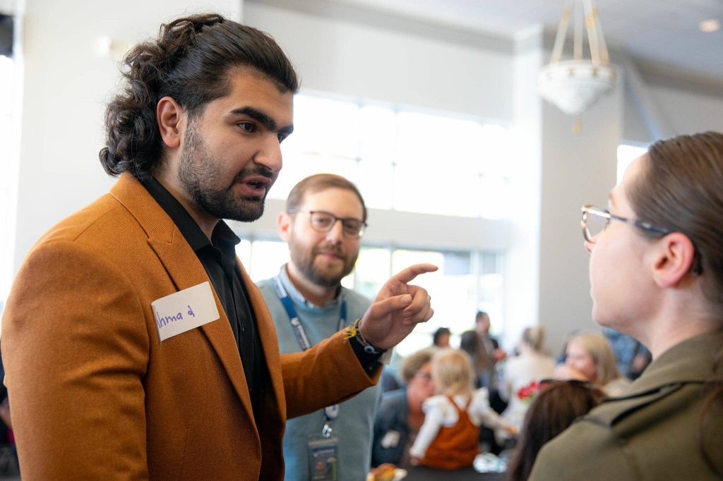 Emerging Leader finalist Ahmad Hilal Abid chats with attendees before the 2024 Snohomish County Emerging Leaders Awards Presentation on Wednesday, April 17, 2024, in Everett, Washington. (Ryan Berry / The Herald)