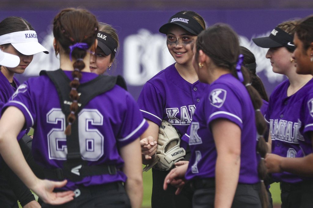 Kamiak players huddle during a 4A softball game between Kamiak and Jackson at Kamiak High School on Tuesday, April 9, 2024 in Mukilteo, Washington. Jackson won, 9-0. (Annie Barker / The Herald)