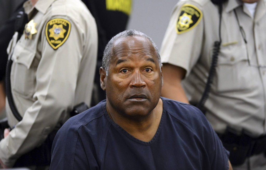 In this May 14, 2013, file photo, O.J. Simpson sits during a break on the second day of an evidentiary hearing in Clark County District Court in Las Vegas. Simpson, the decorated football superstar and Hollywood actor who was acquitted of charges he killed his former wife and her friend but later found liable in a separate civil trial, has died. He was 76. (AP Photo/Ethan Miller, Pool, File)