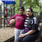 Anila Gill, right, and one of her sons Zion Gill, 8, at the apartment complex they live at on Friday, April 26, 2024 in Lynnwood, Washington. (Olivia Vanni / The Herald)