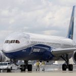FILE - In this Friday, March 31, 2017, file photo, Boeing employees walk the new Boeing 787-10 Dreamliner down towards the delivery ramp area at the company's facility in South Carolina after conducting its first test flight at Charleston International Airport in North Charleston, S.C. Federal safety officials aren't ready to give back authority for approving new planes to Boeing when it comes to the large 787 jet, which Boeing calls the Dreamliner, Tuesday, Feb. 15, 2022. The plane has been plagued by production flaws for more than a year.(AP Photo/Mic Smith, File)