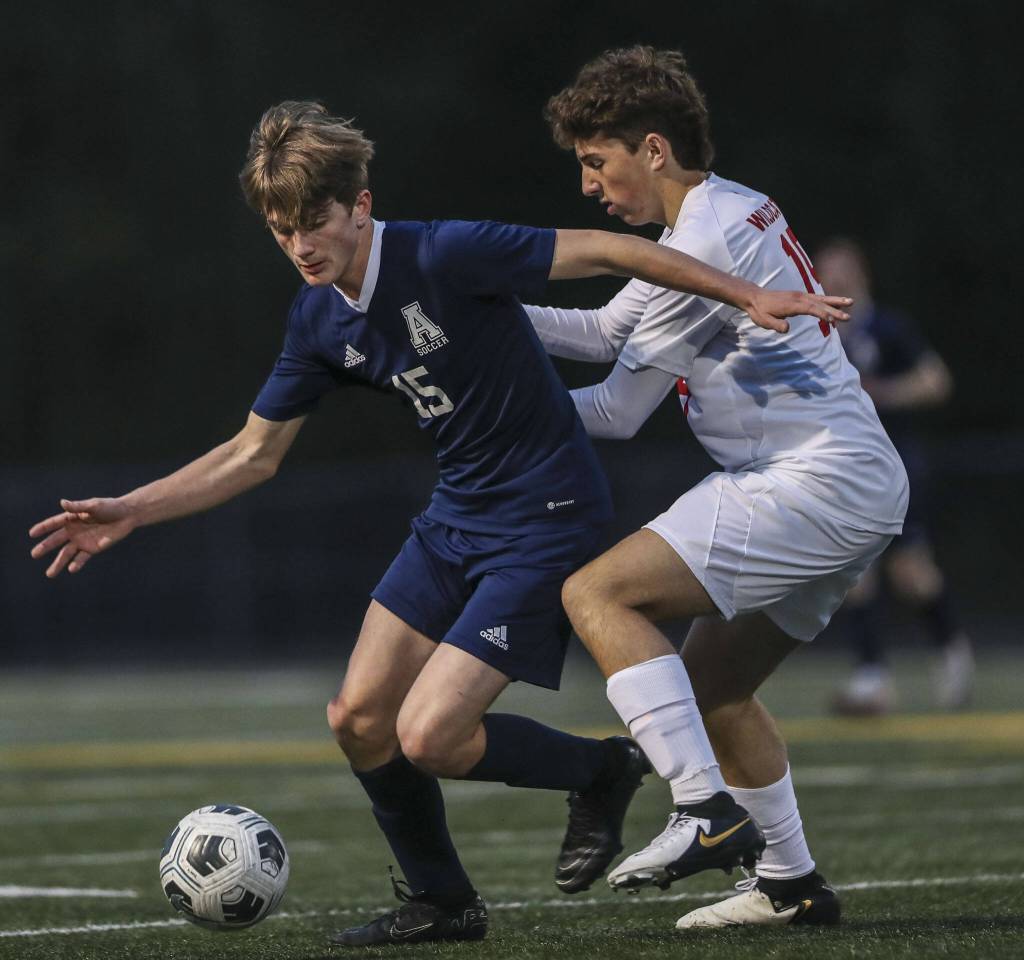 Arlingtons Scott Rutherford (15) moves with the ball during a boys soccer game between Archbishop Murphy and Arlington at Arlington High School on Monday, April 15, 2024 in Arlington, Washington. (Annie Barker / The Herald)