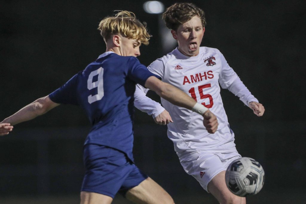 Archbishop Murphys Parker Campbell (15) and Arlingtons Brody Dalgaard (9) fight for the ball during a boys soccer game between Archbishop Murphy and Arlington at Arlington High School on Monday, April 15, 2024 in Arlington, Washington. (Annie Barker / The Herald)
