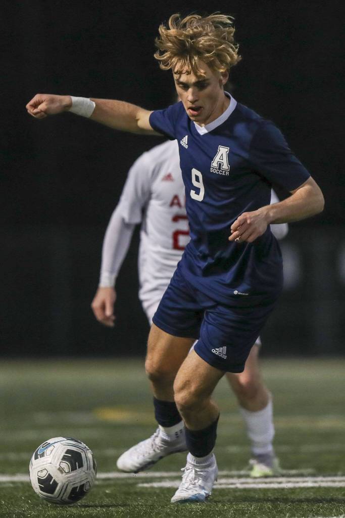 Arlingtons Brody Dalgaard (9) moves with the ball during a boys soccer game between Archbishop Murphy and Arlington at Arlington High School on Monday, April 15, 2024 in Arlington, Washington. (Annie Barker / The Herald)
