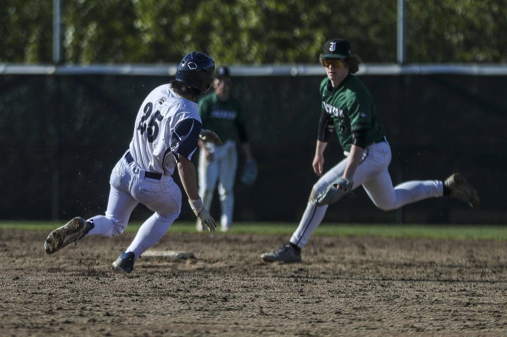 Glacier Peaks Lucas Entler (25) dives for second during a baseball game between Jackson and Glacier Peak at Glacier Peak High School on Tuesday, April 16, 2024 in Snohomish, Washington. Glacier Peak won 3-0. (Annie Barker / The Herald)