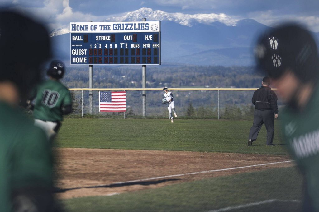 Players swap positions at the top of the sixth during a baseball game between Jackson and Glacier Peak at Glacier Peak High School on Tuesday, April 16, 2024 in Snohomish, Washington. Glacier Peak won 3-0. (Annie Barker / The Herald)