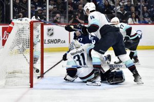 The Winnipeg Jets Nikolaj Ehlers (27) scores on Seattle Kraken goaltender Philipp Grubauer (31) during the second period of their game Tuesday in Winnipeg, Manitoba. (Fred Greenslade/The Canadian Press via AP)