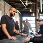 Craig Chambers chats with a couple of guests while tending the bar at Obsidian Beer Hall on Friday, April 12, 2024, in downtown Everett, Washington. (Ryan Berry / The Herald)