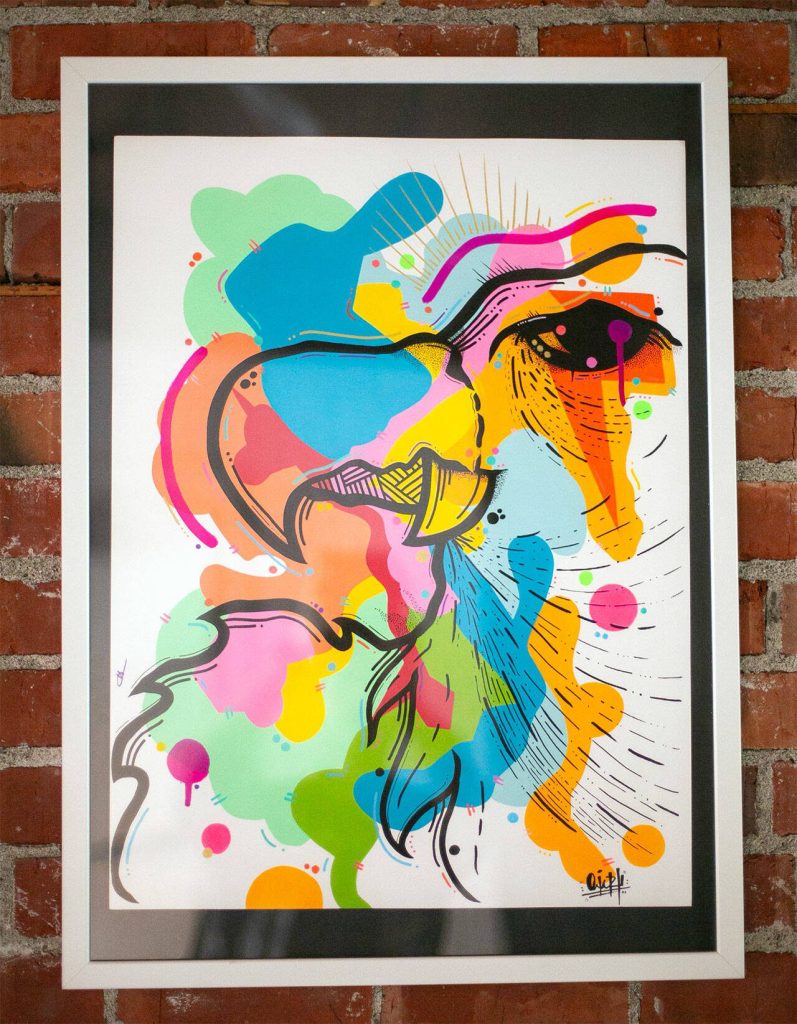 Artwork by Colombian-born OviArt hangs on a wall at Obsidian Beer Hall on Friday, April 12, 2024, in downtown Everett, Washington. (Ryan Berry / The Herald)