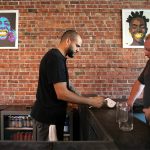 Craig Chambers takes orders while working behind the bar at Obsidian Beer Hall on Friday, April 12, 2024, in downtown Everett, Washington. (Ryan Berry / The Herald)