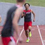 Stanwoods leadoff runner in the boys 1,600-meter relay grimaces while running toward his teammate during the Eason Invitational at Snohomish High School on Saturday, April 20, 2024 in Snohomish, Washington. (Olivia Vanni / The Herald)