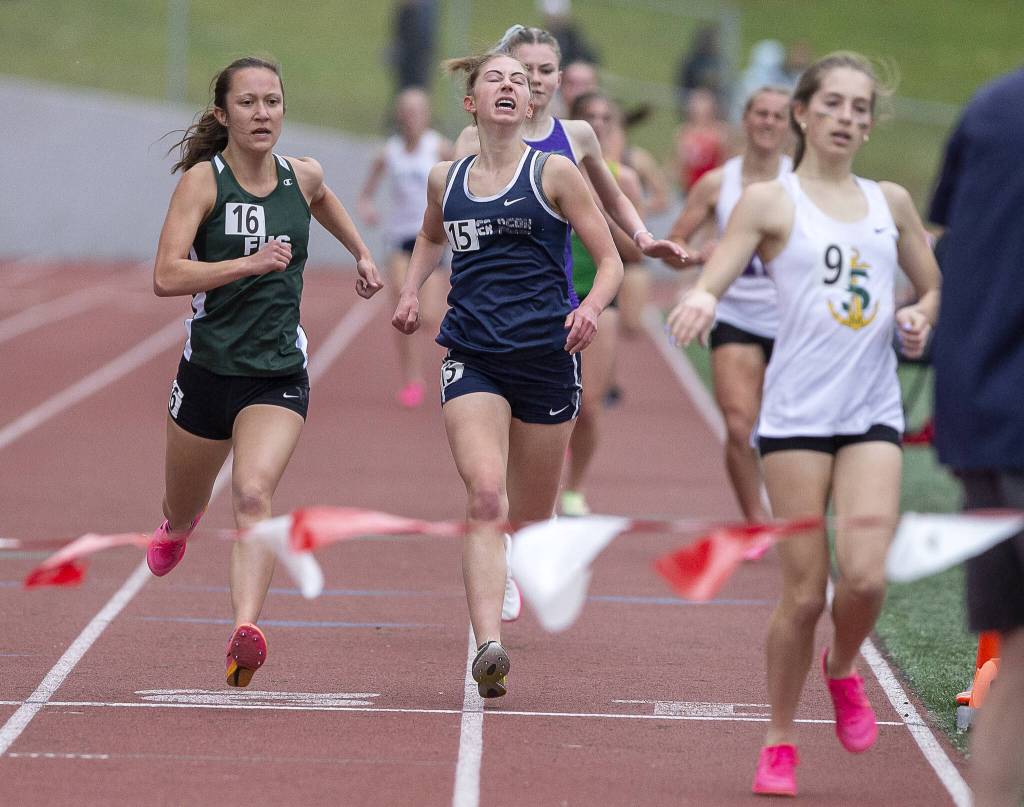 Glacier Peaks Clara Diepenbrock grimaces as she crosses the finish line in the girls 1,600 meters during the Eason Invitational at Snohomish High School on Saturday, April 20, 2024 in Snohomish, Washington. (Olivia Vanni / The Herald)