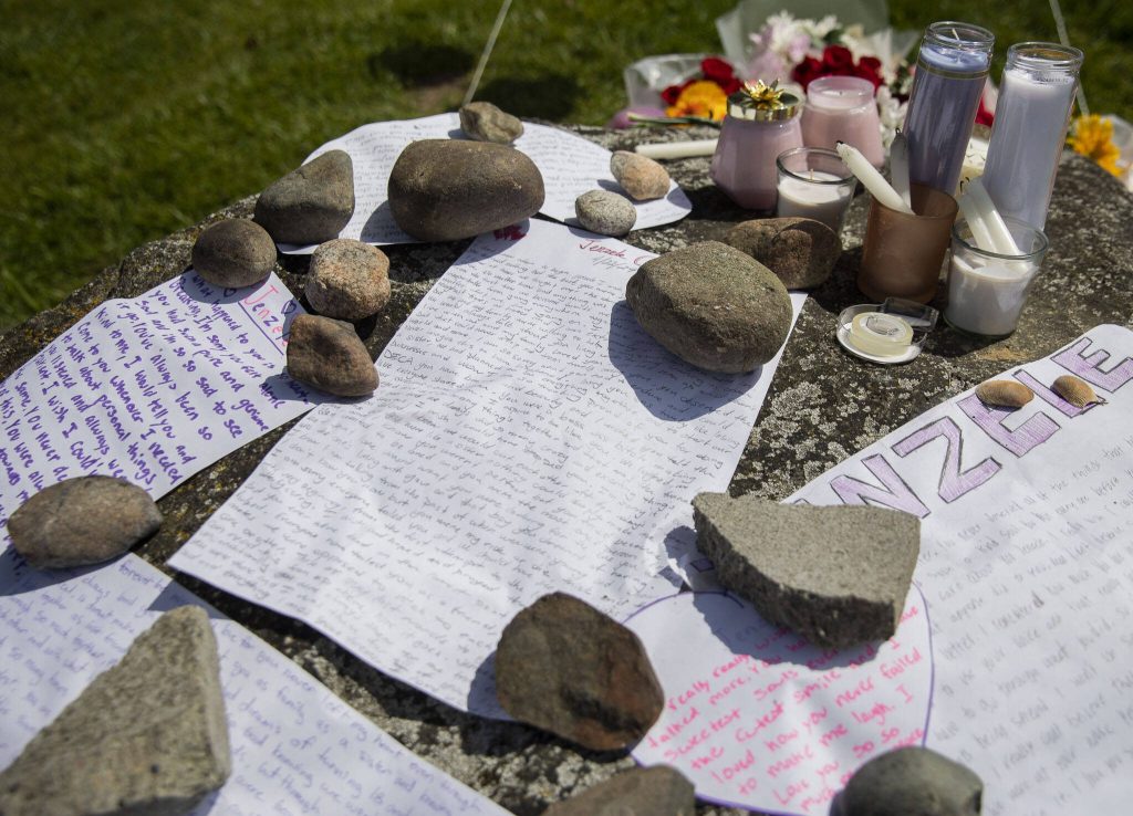 Notes cover the top of a rock set up as a memorial for Jenzele Couassi on Tuesday, April 23, 2024 in Tulalip, Washington. (Olivia Vanni / The Herald)