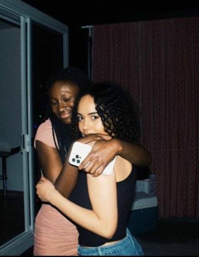 Manuela Kouloun (left) hugs her cousin Jenzele Couassi at a 2023 New Years Eve celebration. Manuela remembers a night of dancing and singing karaoke. (Photo provided by Manuela Kouloun)