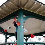 People hang up hearts with messages about saving the Clark Park gazebo during a “heart bomb” event hosted by Historic Everett on Saturday, Feb. 17, 2024 in Everett, Washington. (Olivia Vanni / The Herald)