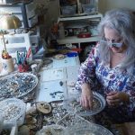 Artist Libby Hammer picks through bits and pieces collected from Whidbey Island beaches recently at her home in Oak Harbor. (Sam Fletcher / Whidbey News-Times)