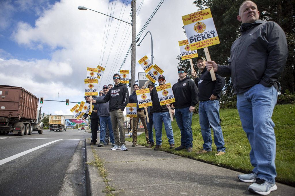 Members of Boeings firefighter union and supporters hold an informational picket at Airport Road and Kasch Park Road on Monday, April 29, 2024 in Everett, Washington. (Annie Barker / The Herald)