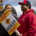 Tony Coleman participates in the Boeing firefighter unions informational picket at Airport Road and Kasch Park Road on Monday, April 29, 2024 in Everett, Washington. (Annie Barker / The Herald)