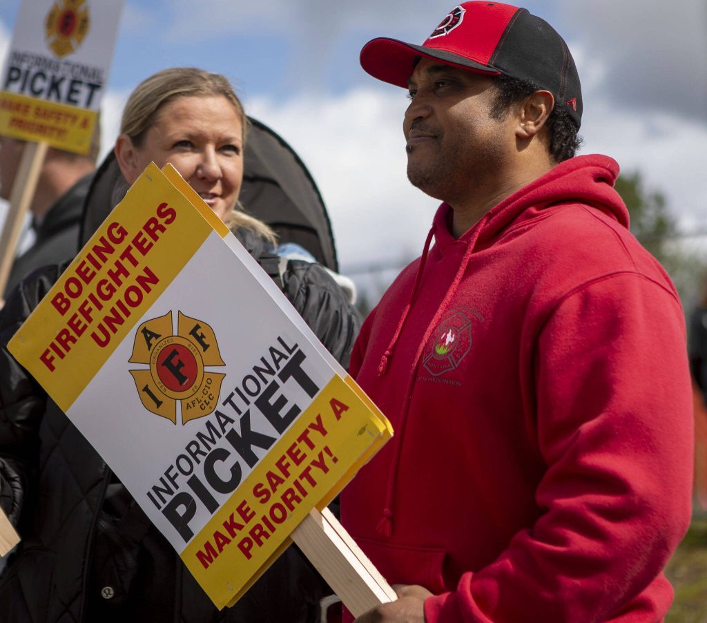Tony Coleman participates in the Boeing firefighter unions informational picket at Airport Road and Kasch Park Road on Monday, April 29, 2024 in Everett, Washington. (Annie Barker / The Herald)