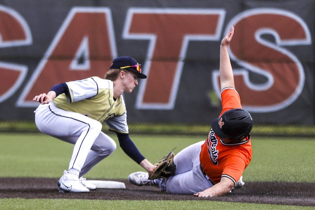 Monroes Brennan Sheppard (8) slides out at second during a baseball game between Monroe and Arlington at Monroe High School on Friday, April 26, 2024 in Monroe, Washington. Monroe secured a win in an eighth inning, 4-3. (Annie Barker / The Herald)