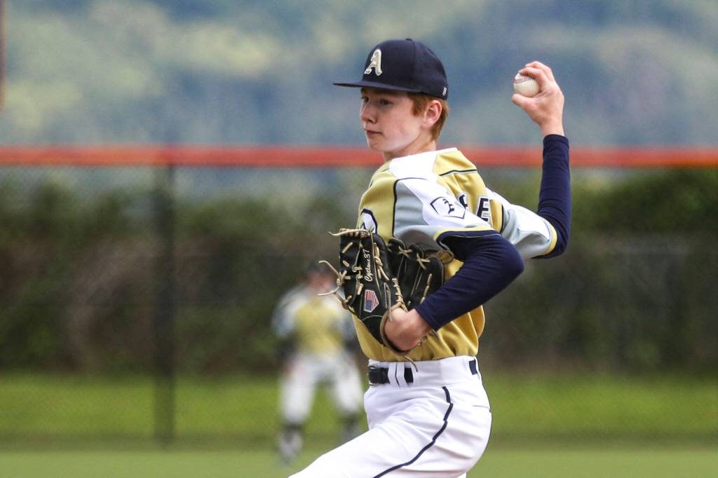 Arlingtons Cy Bradley (0) pitches during a baseball game between Monroe and Arlington at Monroe High School on Friday, April 26, 2024 in Monroe, Washington. Monroe secured a win in an eighth inning, 4-3. (Annie Barker / The Herald)