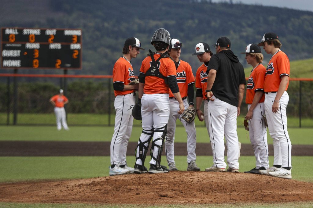 Monroe players huddle during a baseball game between Monroe and Arlington at Monroe High School on Friday, April 26, 2024 in Monroe, Washington. Monroe secured a win in an eighth inning, 4-3. (Annie Barker / The Herald)