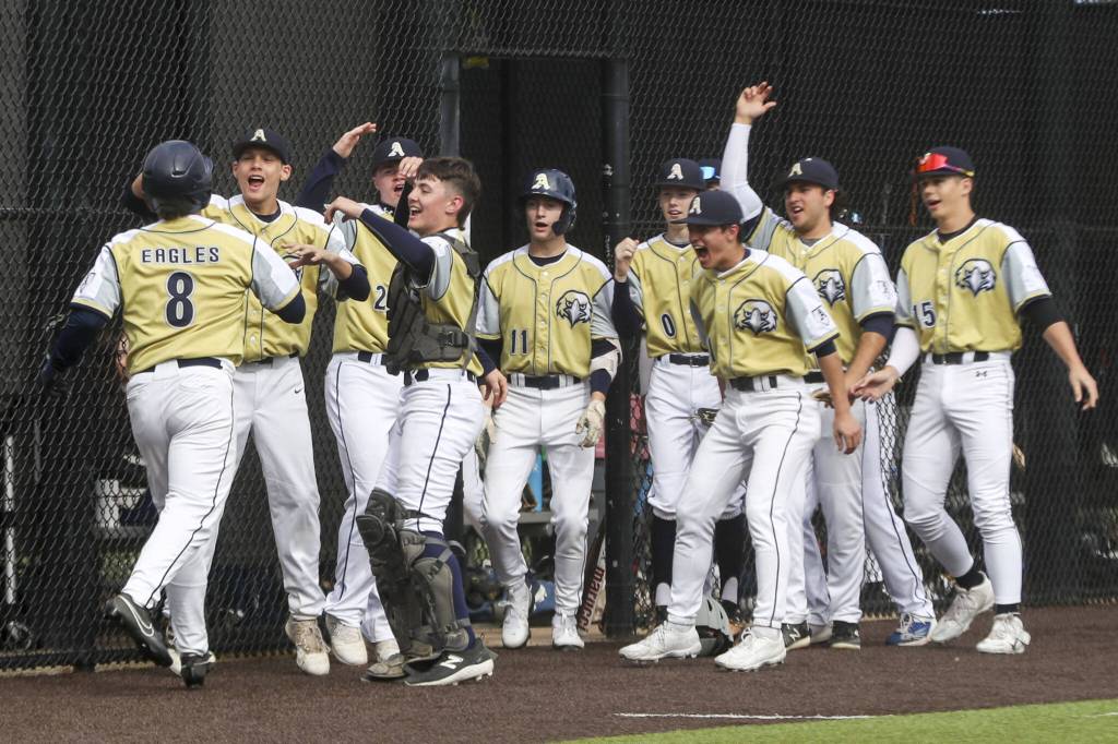 Arlington players celebrate during a baseball game between Monroe and Arlington at Monroe High School on Friday, April 26, 2024 in Monroe, Washington. Monroe secured a win in an eighth inning, 4-3. (Annie Barker / The Herald)