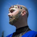 Gina Touche’s glitter beard and jewels shine in the sunlight at Arlington’s first-ever Pride celebration on Saturday, June 4, 2022. (Olivia Vanni / The Herald)