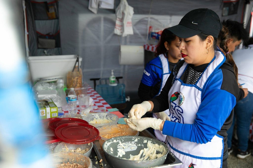 A team of workers make Salvadoran pupusas at the Hidden Gems Weekend Market on Sunday, April 28, 2024, at Boom City in Tulalip, Washington. (Ryan Berry / The Herald)