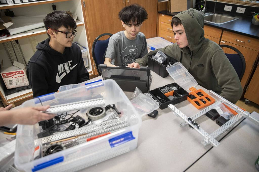 Ayden TheBoy-Jones, left, Kenco Hinrichs and Jalen Morrical work together on a VEX Robotics project at Tulalip Heritage High School on Wednesday, April 24, 2024 in Marysville, Washington. (Olivia Vanni / The Herald)