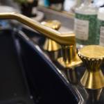 Gold plated sink fixtures in a bathroom. (Olivia Vanni / The Herald)