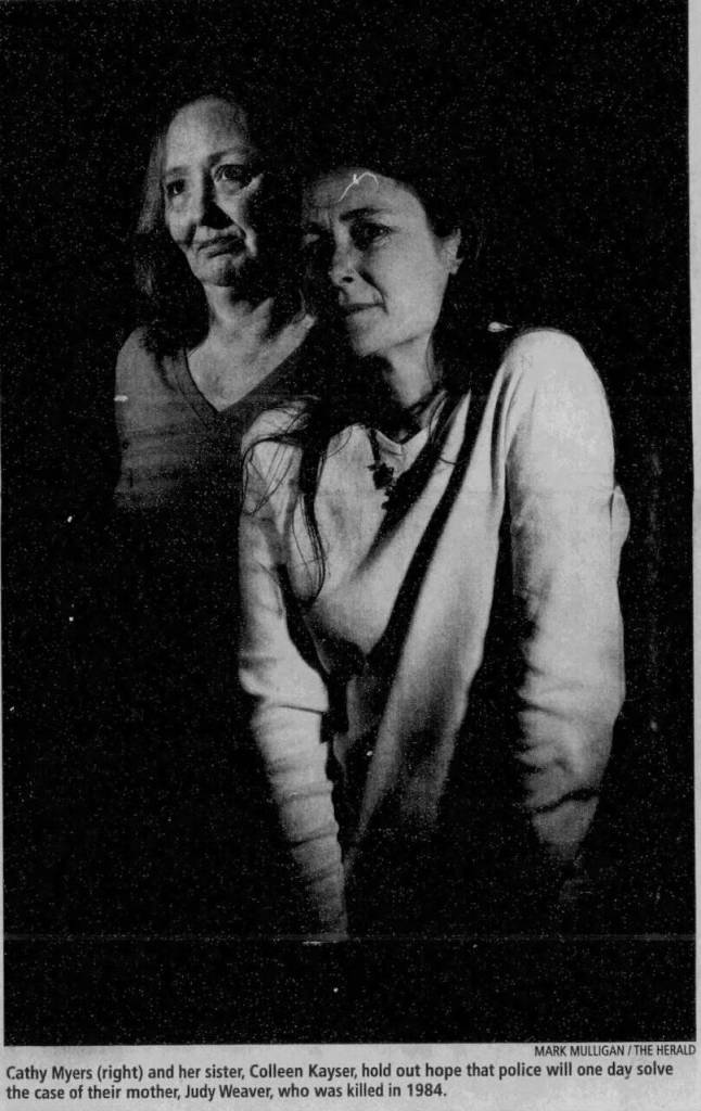 Cathy Myers (right) and her sister, Colleen Kayster, hold out hope that police will one day sold the case of their mother, Judy Weaver, who was killed in 1984. This photo originally appeared in The Everett Daily Herald on June 3, 2009. (Mark Mulligan / The Herald file)