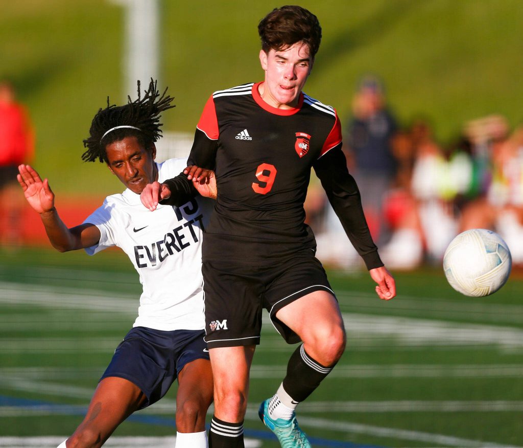 Monroes Connor Dayley and Everetts Sean Wright collide while chasing down the ball during a 3A District soccer match on Thursday, May 2, 2024, at Monroe High School in Monroe, Washington. (Ryan Berry / The Herald)