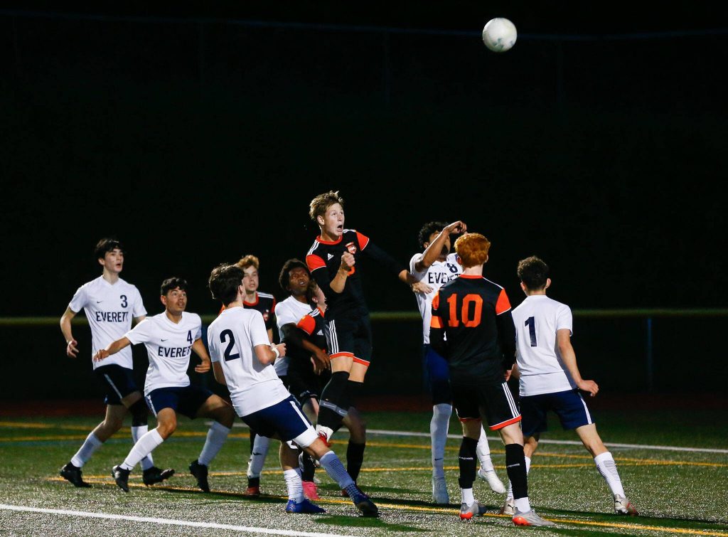 Monroe and Everett players go up for a corner kick during a 3A District soccer match on Thursday, May 2, 2024, at Monroe High School in Monroe, Washington. (Ryan Berry / The Herald)