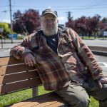 George Beard poses for a photo outside of the the Stanwood Library in Stanwood, Washington on Wednesday, May 8, 2024.  (Annie Barker / The Herald)