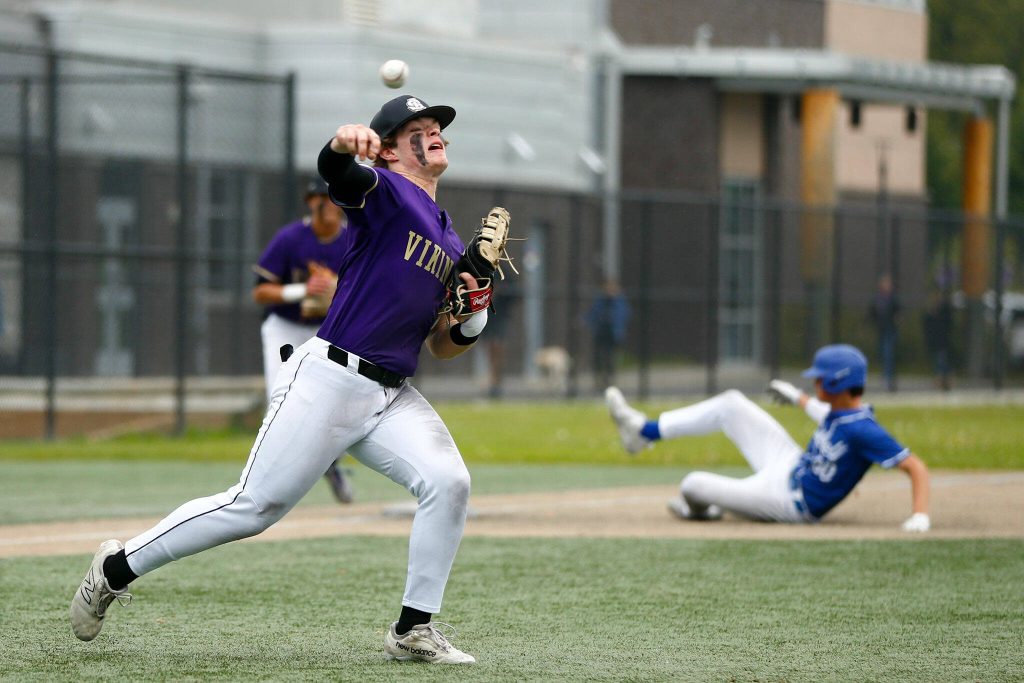 Lake Stevens first baseman AAlona DeMartin fields bunt and throws out the runner during a playoff loss to Bothell on Saturday, May 4, 2024, in Lake Stevens, Washington. (Ryan Berry / The Herald)