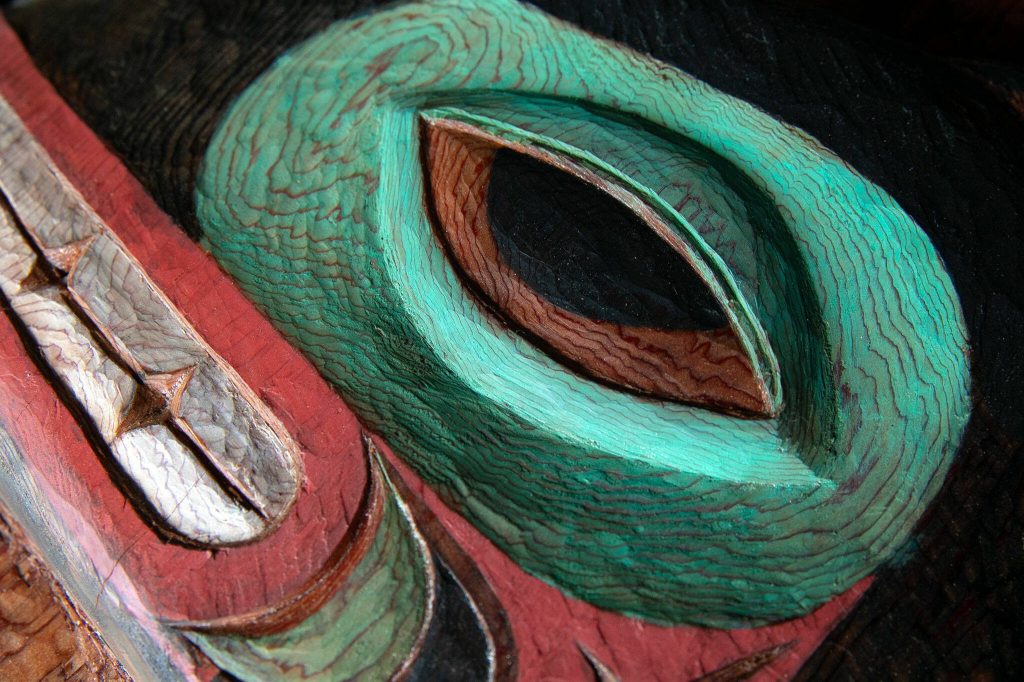 Fine detail can be seen in the eye of a wolf on a totem pole created by Fred Fulmer on Wednesday, May 8, 2024, at his home in Everett, Washington. (Ryan Berry / The Herald)