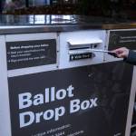A person turns in their ballot at a ballot box located near the Edmonds Library in Edmonds, Washington on Sunday, Nov. 5, 2023. (Annie Barker / The Herald)