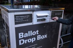 A person turns in their ballot at a ballot box located near the Edmonds Library in Edmonds, Washington on Sunday, Nov. 5, 2023. (Annie Barker / The Herald)